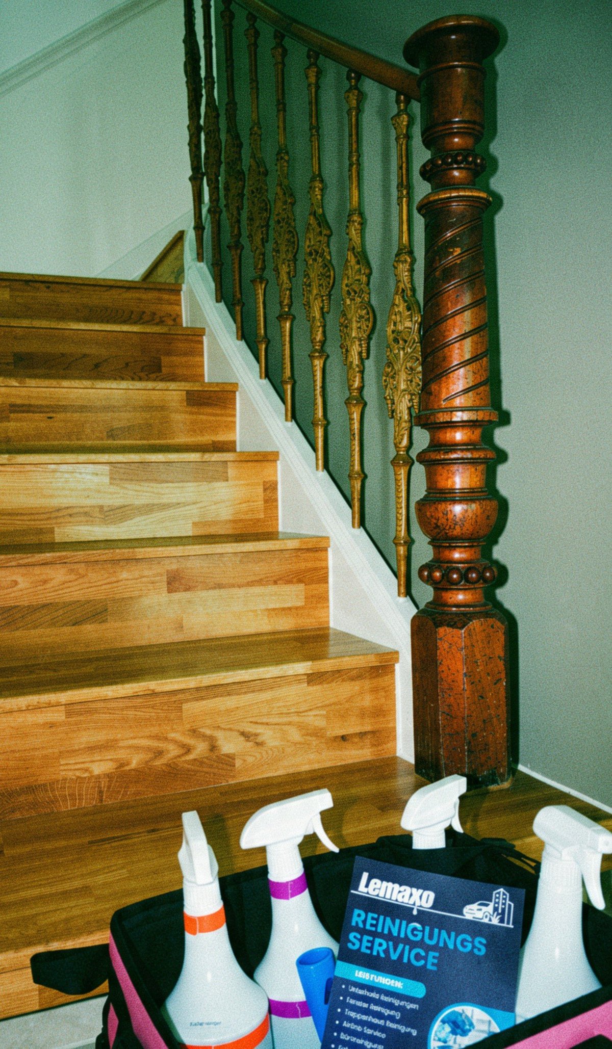 Wooden staircase with ornate dark wood banister and metal spindles beside cleaning supplies including spray bottles and service brochure